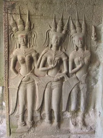 Apsara dancers carved in stone relief at an Angkor temple, the original inspiration for the dance