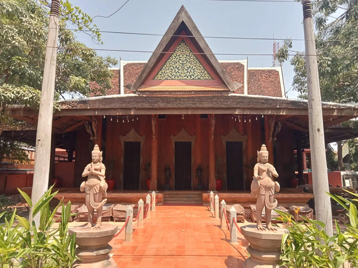 The entrance of an Apsara dance theatre in Siem Reap, flanked by stone Apsara statues